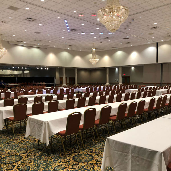 ballroom lined with tables for corporate event