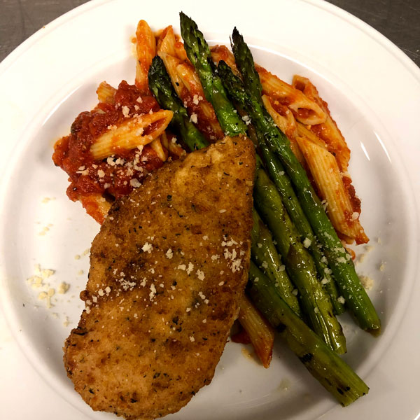 delicious meal plate of chicken, asparagus, and pasta